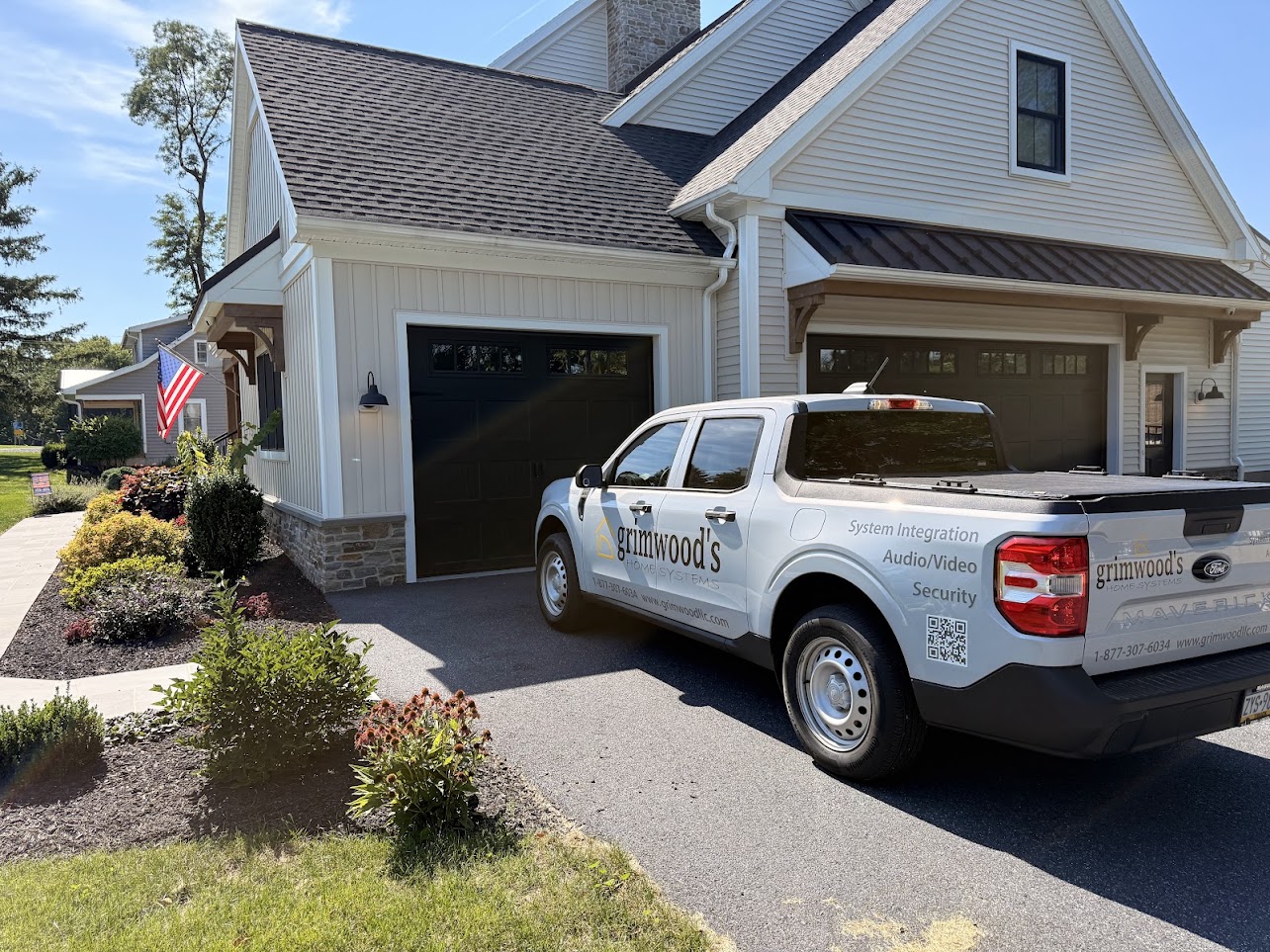 Grimwood’s Home Systems Ford Maverick outside a Lancaster, PA, home with an American flag.
