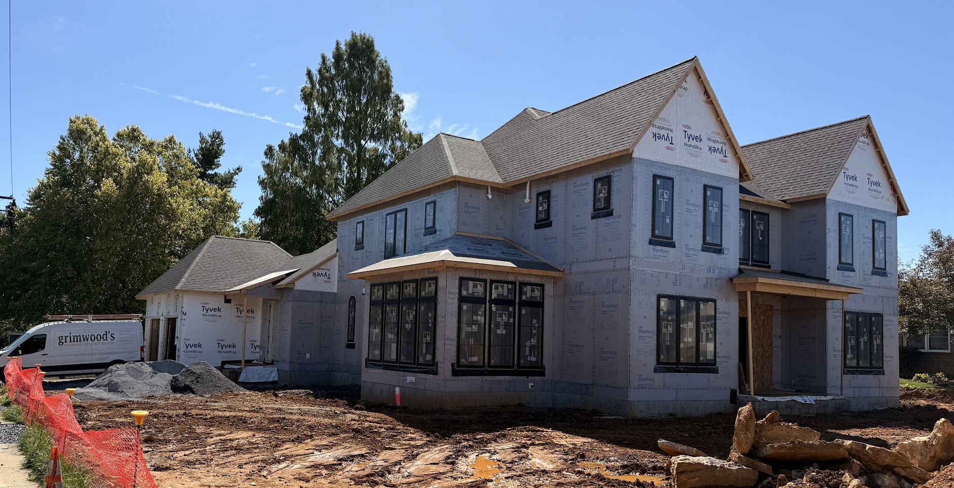 Wide view of a Hershey, PA, home under construction, with the Grimwood’s Home Systems work van alongside.