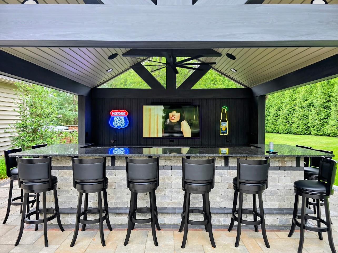 Outdoor bar with an installed television and ceiling speakers