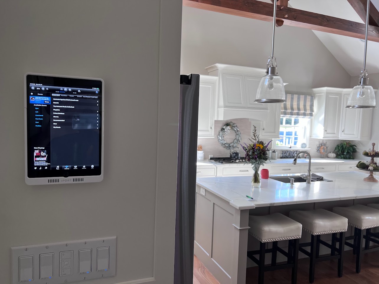 Installed wall-control tablet beside a kitchen