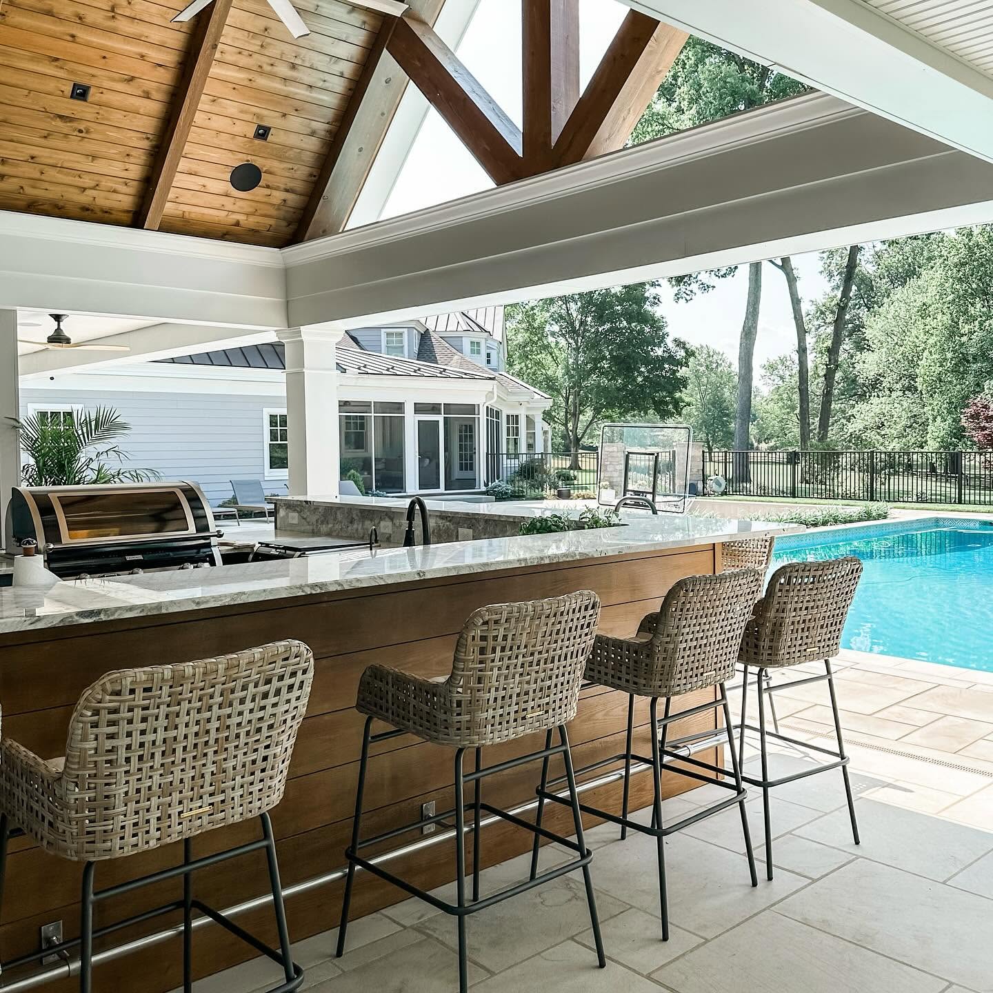 Pool house bar and living space with installed audio, video, surveillance, and outdoor wireless networking